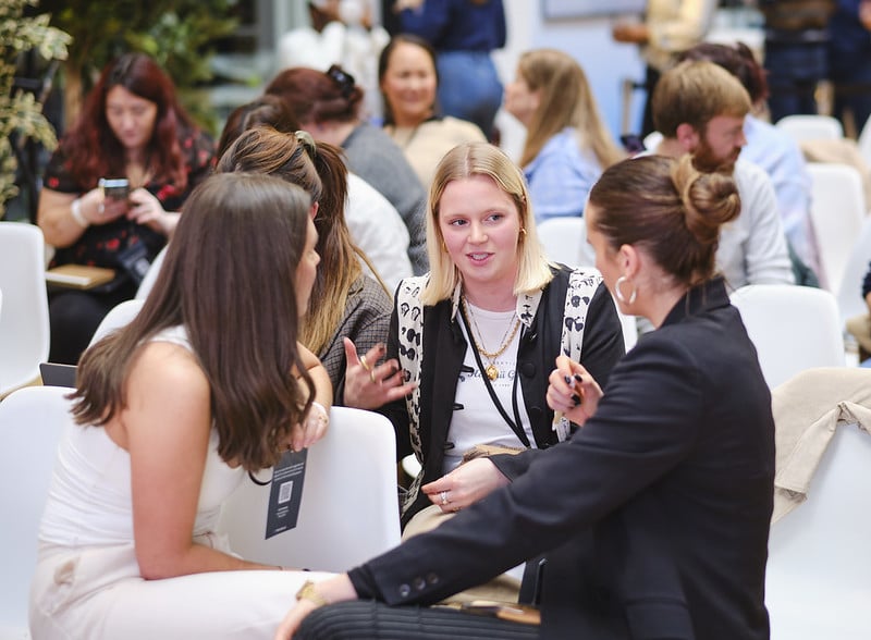 A small group deep in conversation at a networking workshop
